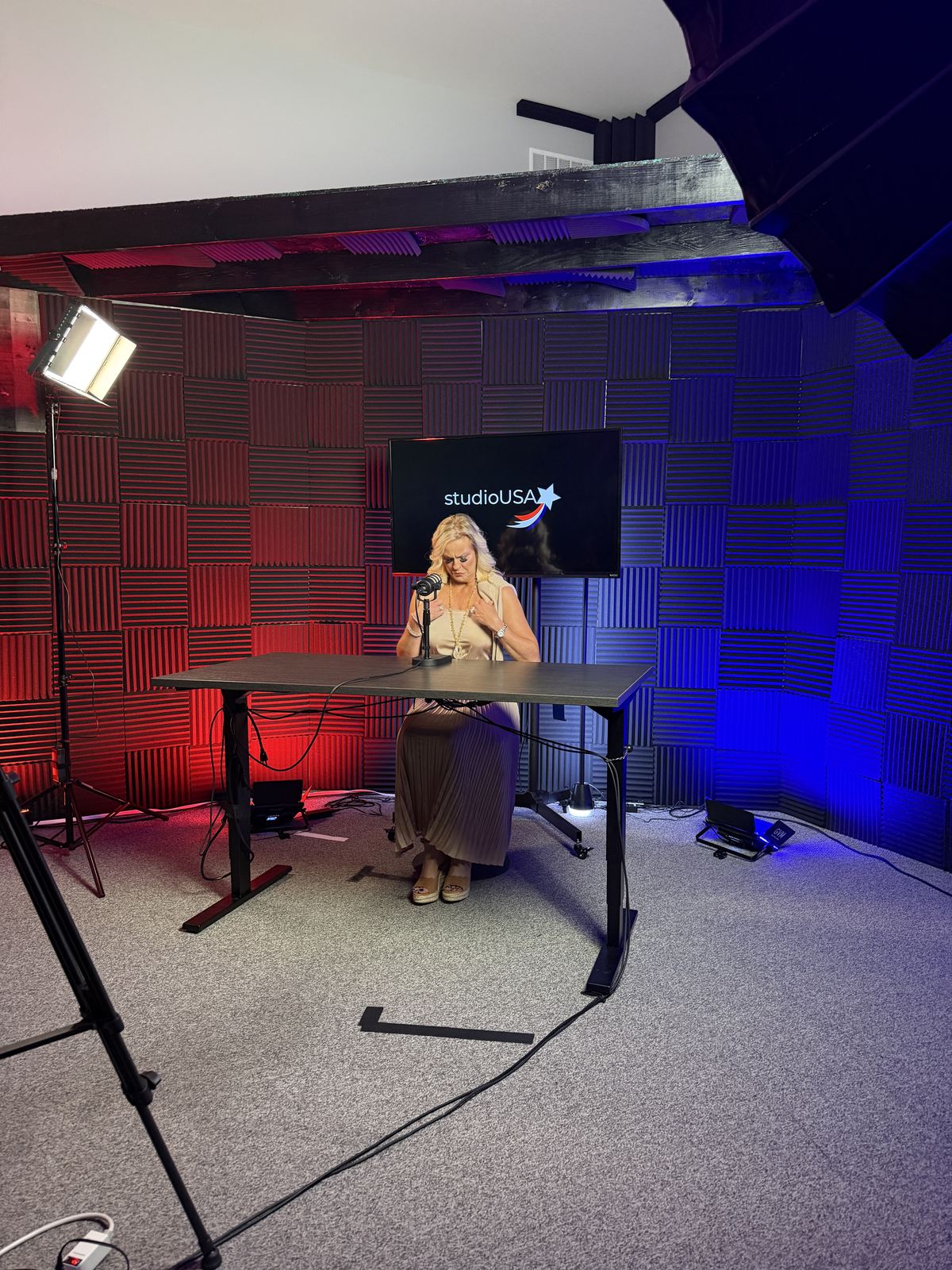 Solo guest recording at the desk on the red and blue set at studioUSA West